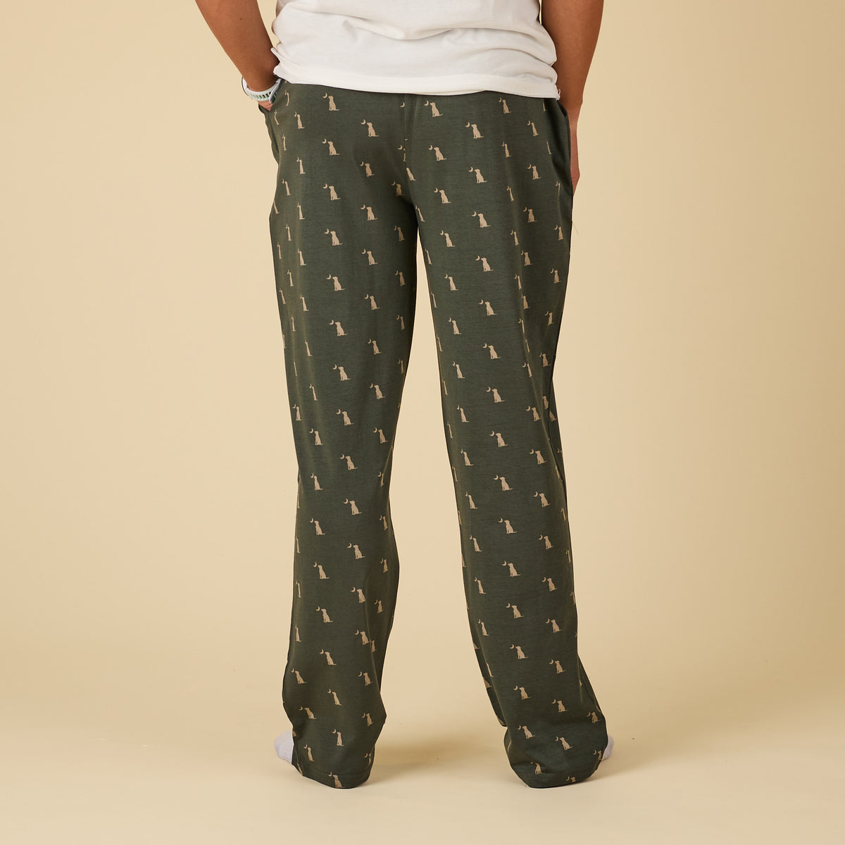 Green patterned pants worn by a person on a beige background