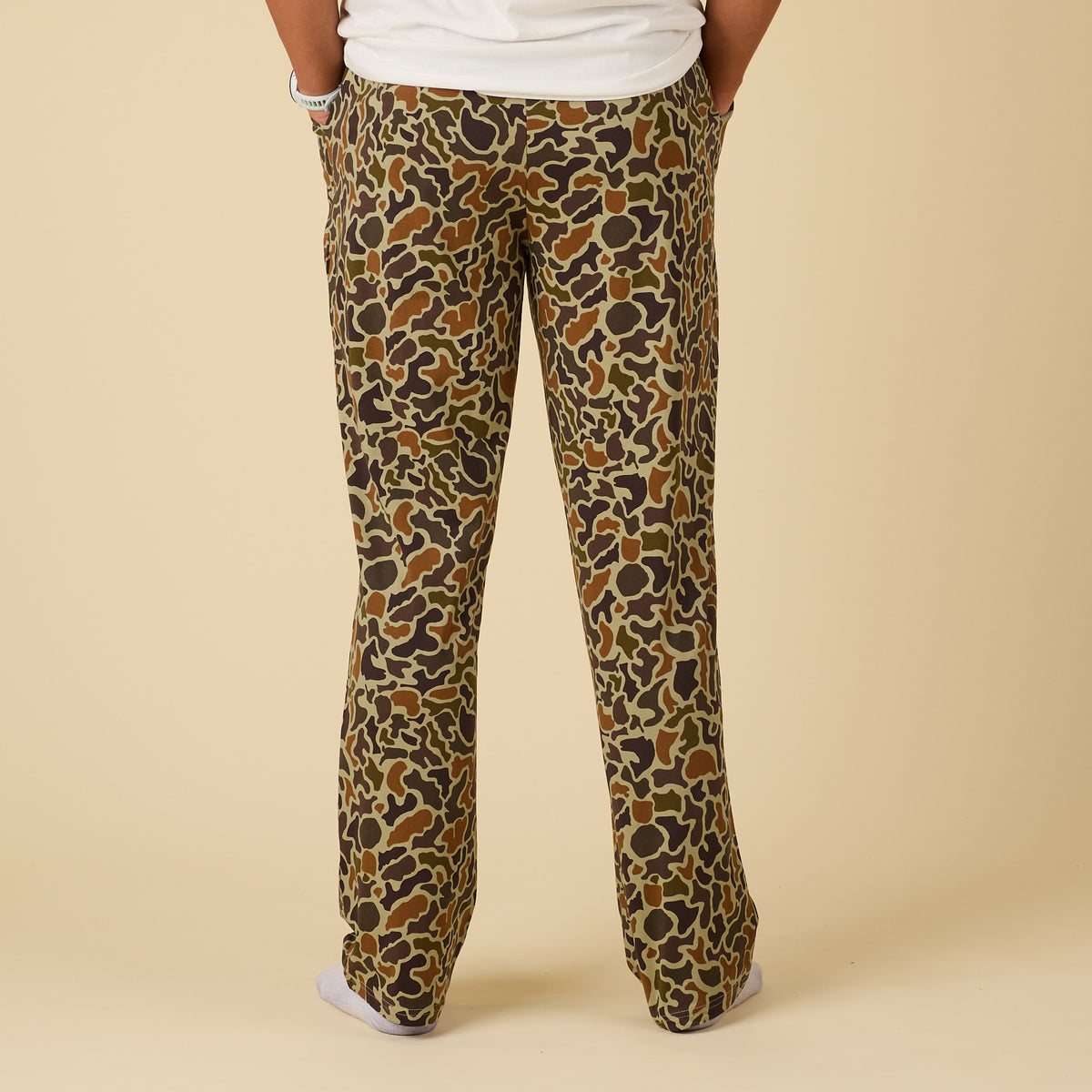 Patterned pants worn by a person on a beige background