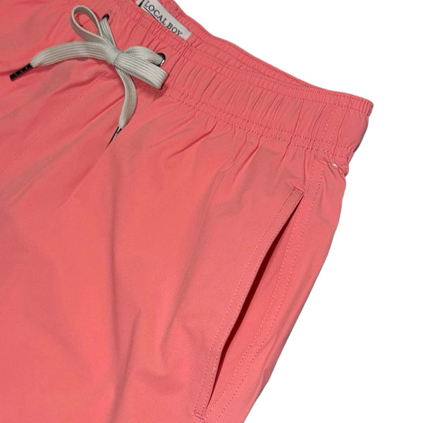 close up of front pocket of Local Boy Outfitters Men's Bayview swim shorts in bright coral