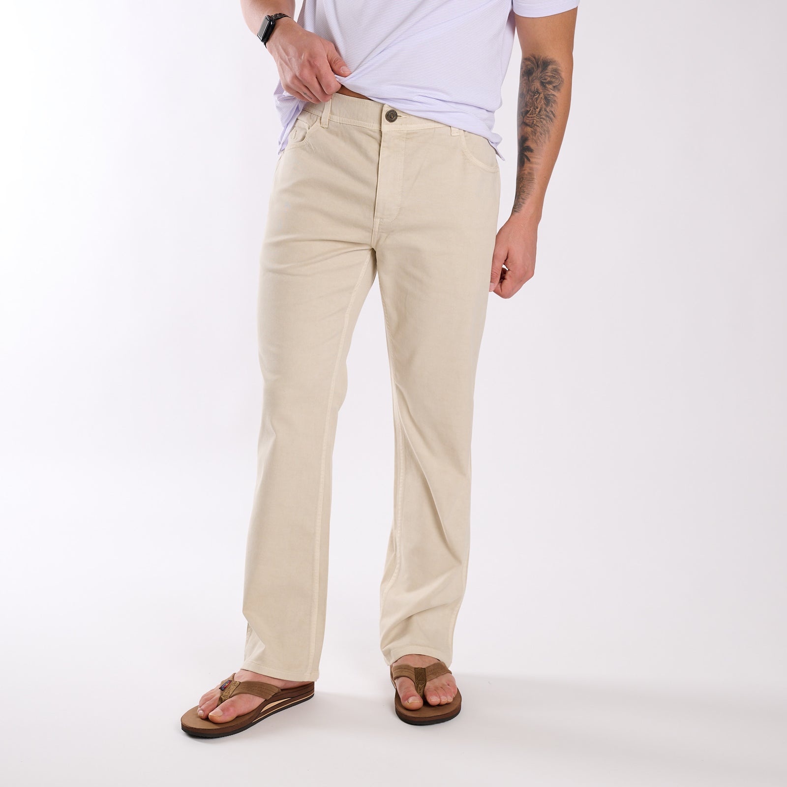Person wearing beige pants on a white background