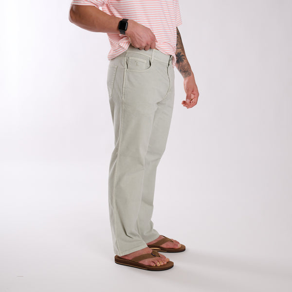 Person wearing light gray pants and a pink striped shirt on a white background