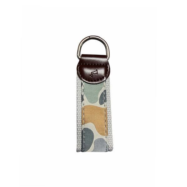 Keychain with camouflage pattern and brown leather accent shown on a white background
