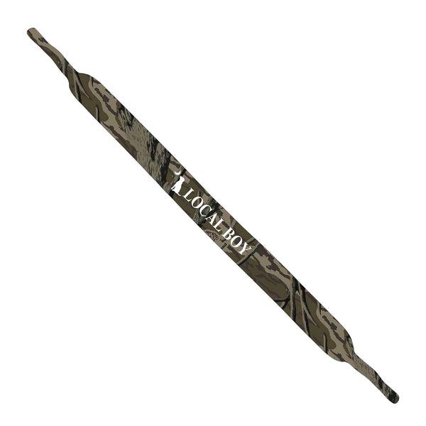 Local boy outfitters neoprene sunglass strap in treestand camo. Shades of brown and green with a white local boy outfitters logo in the middle.