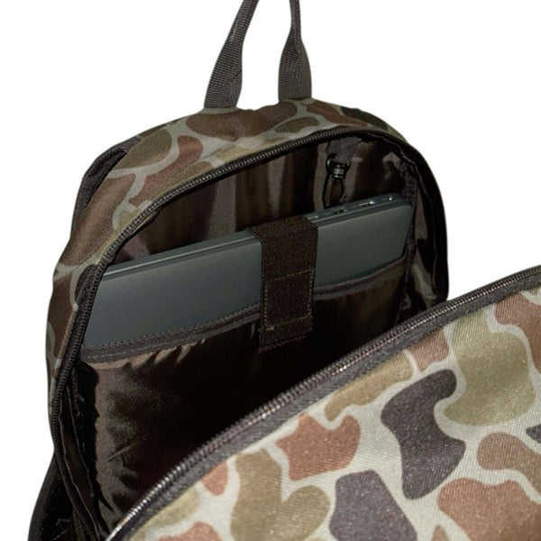 Interior view of the Localflage Camo backpack showing padded laptop sleeve with securing strap and mesh zip pocket.