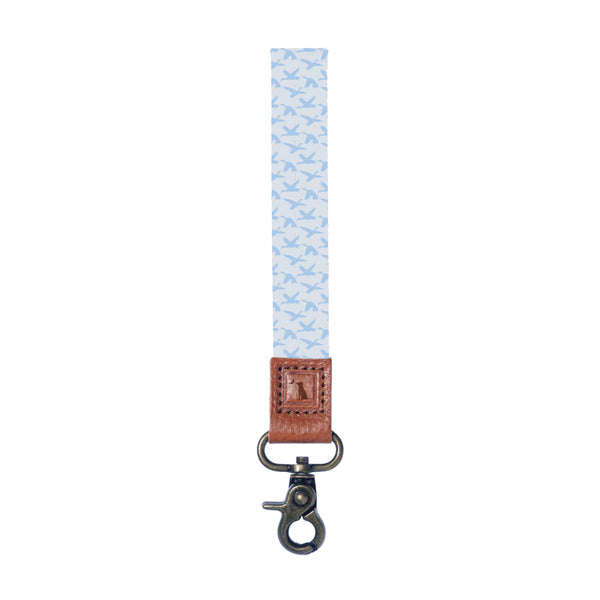Local Boy Outfitters wrist lanyard with white base and light blue mallard silhouettes in flight and metal clasp on a white background