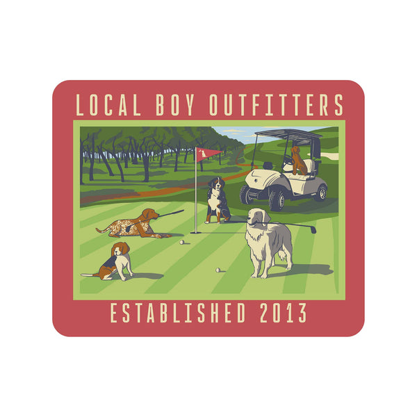 Golf-themed design with dogs and a golf cart on a green field, featuring 'Local Boy Outfitters' branding.