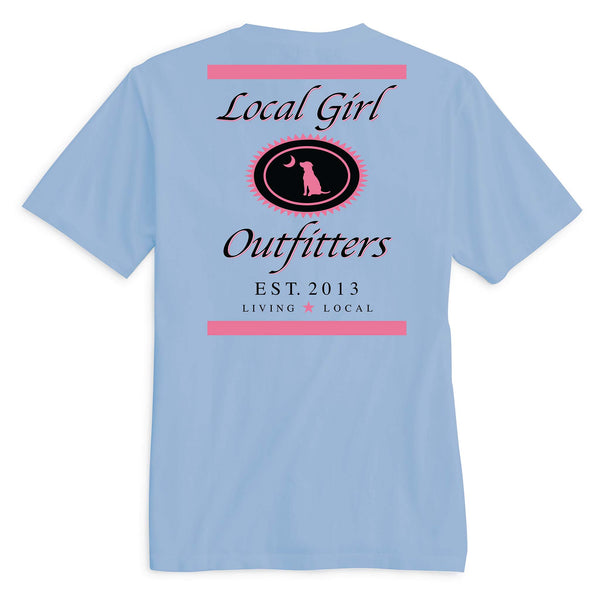  Local Girl Outfitters short sleeve t-shirt, color hydrangea, sizes S-XXL, 100% cotton. Back features pink and black crest with dog and moon, “Living Local” and “Est. 2013” text.