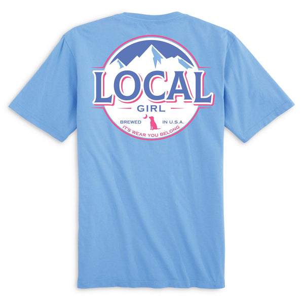Local Girl Outfitters short sleeve t-shirt, color washed denim, sizes S-XXL, 100% cotton. Back design has a pink, blue, & white mountain circle logo with “Local Girl” and tagline “It’s Wear You Belong.”