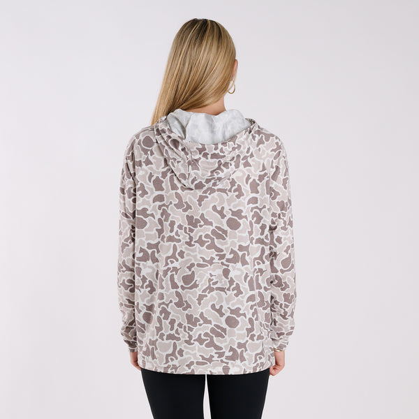 Person wearing a patterned jacket on a plain background