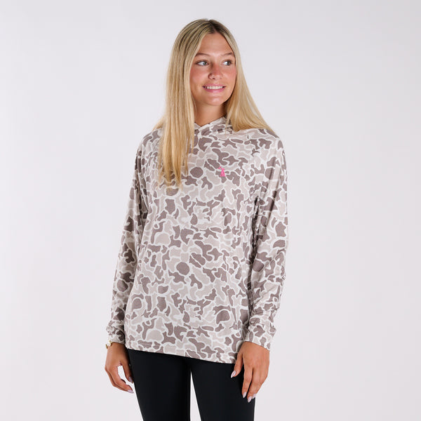 Woman wearing a patterned long-sleeve shirt on a white background