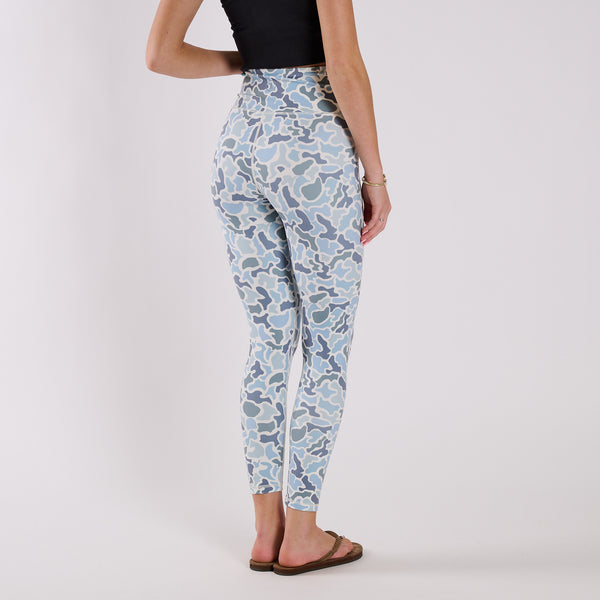 Angled back view of blue camo leggings displaying fitted silhouette and tapered ankle length.
