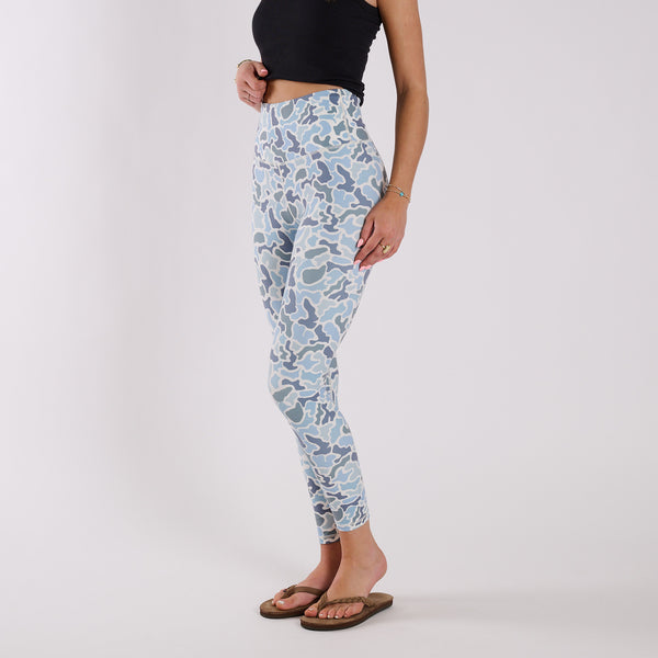Side view of fitted blue camo leggings highlighting contoured seams and ankle-length silhouette.