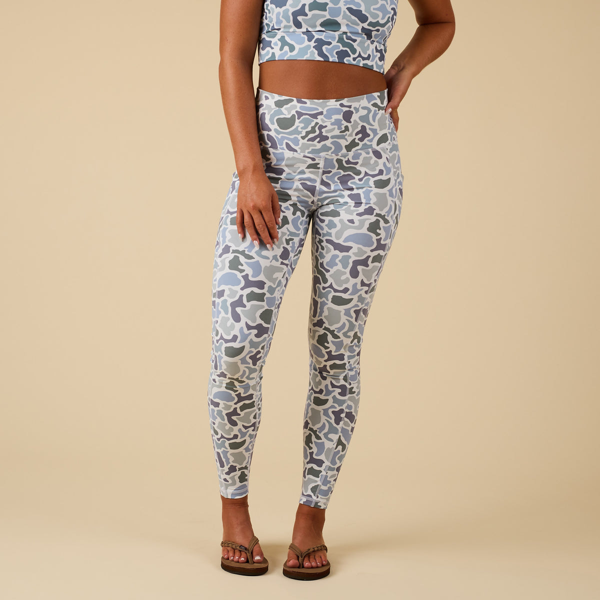 Local Girl high-waisted leggings in blue, gray, and white camouflage print, shown from the front on model with matching crop top.
