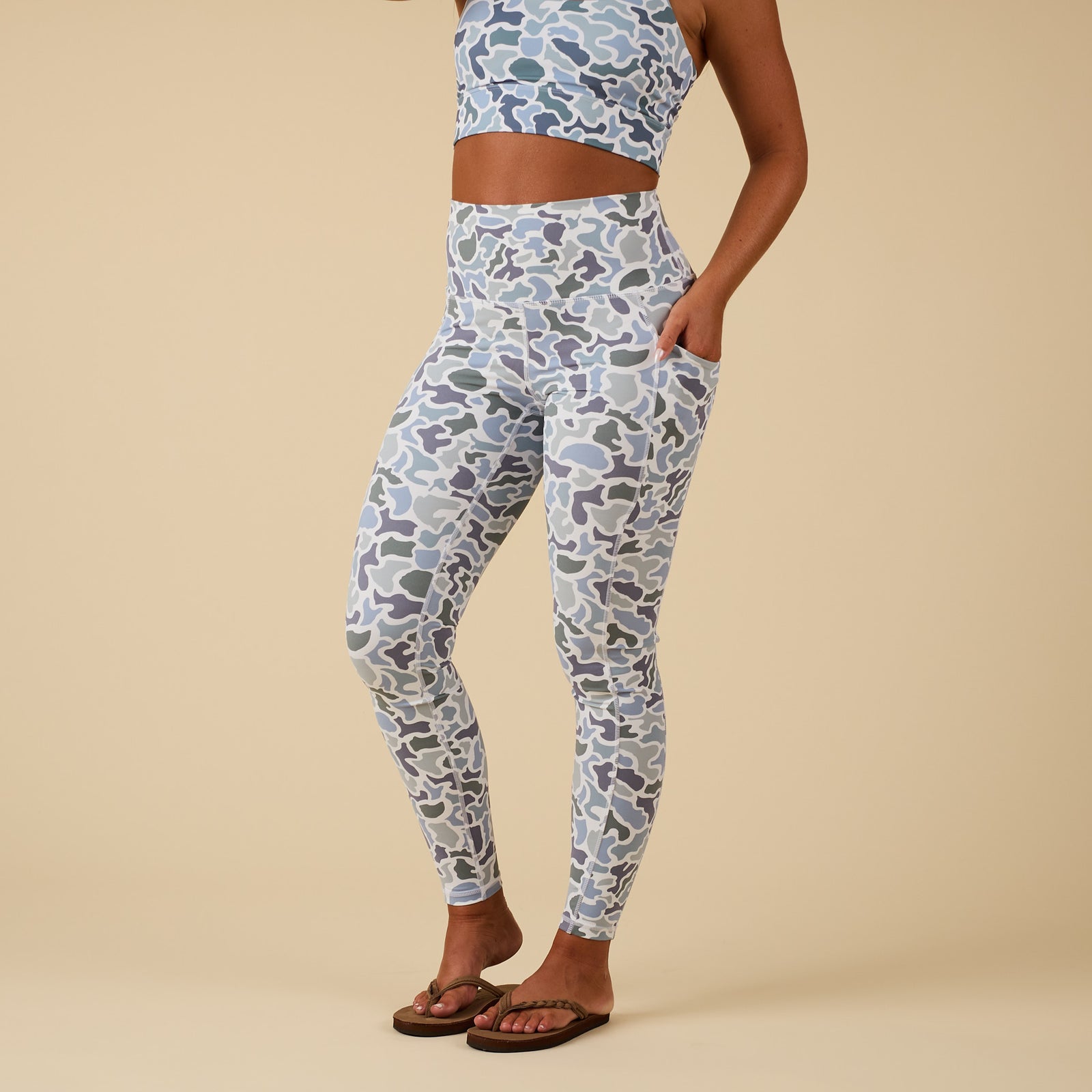 Local Girl high-waisted camo print leggings with side pocket, shown on model in partial side view.