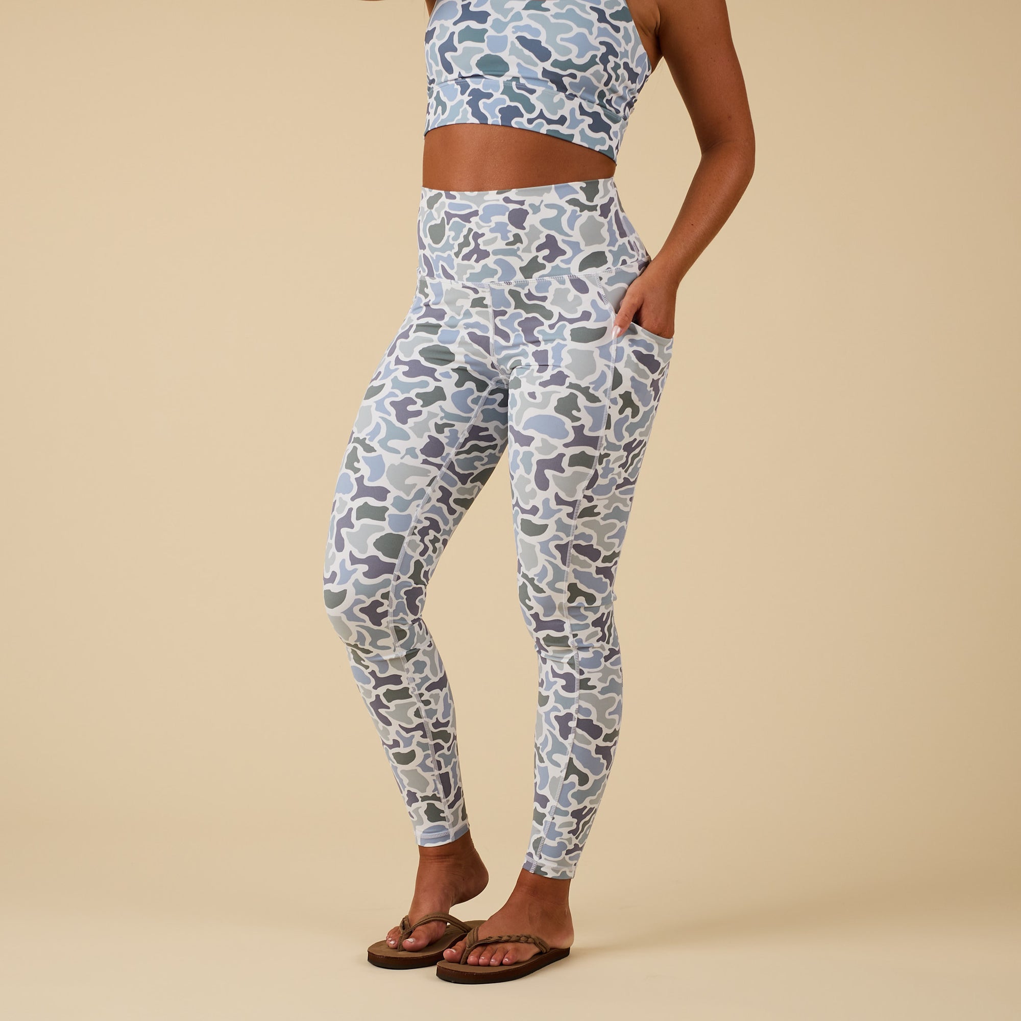 Local Girl high-waisted camo print leggings with side pocket, shown on model in partial side view.
