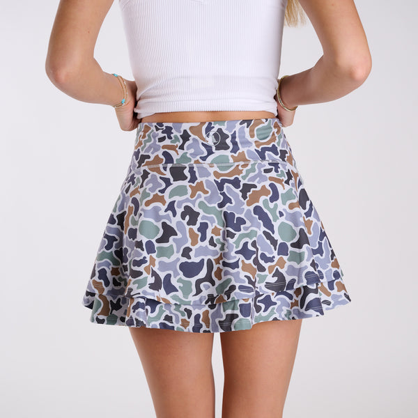 Multicolor camo skort back view with wide waistband and tiered skirt design.