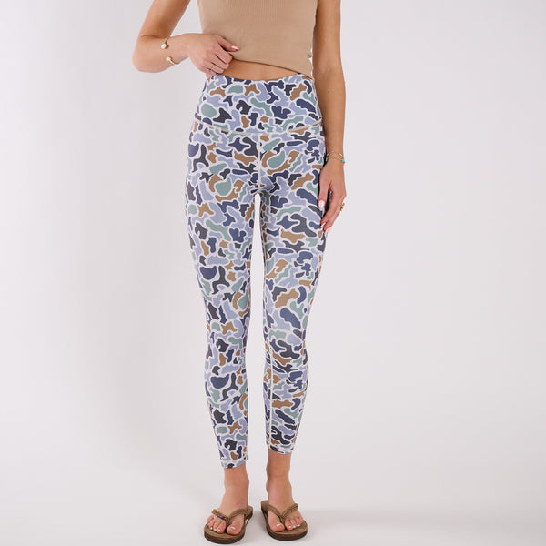 Front view of high-waisted camo leggings paired with cropped tank and sandals against white backdrop.