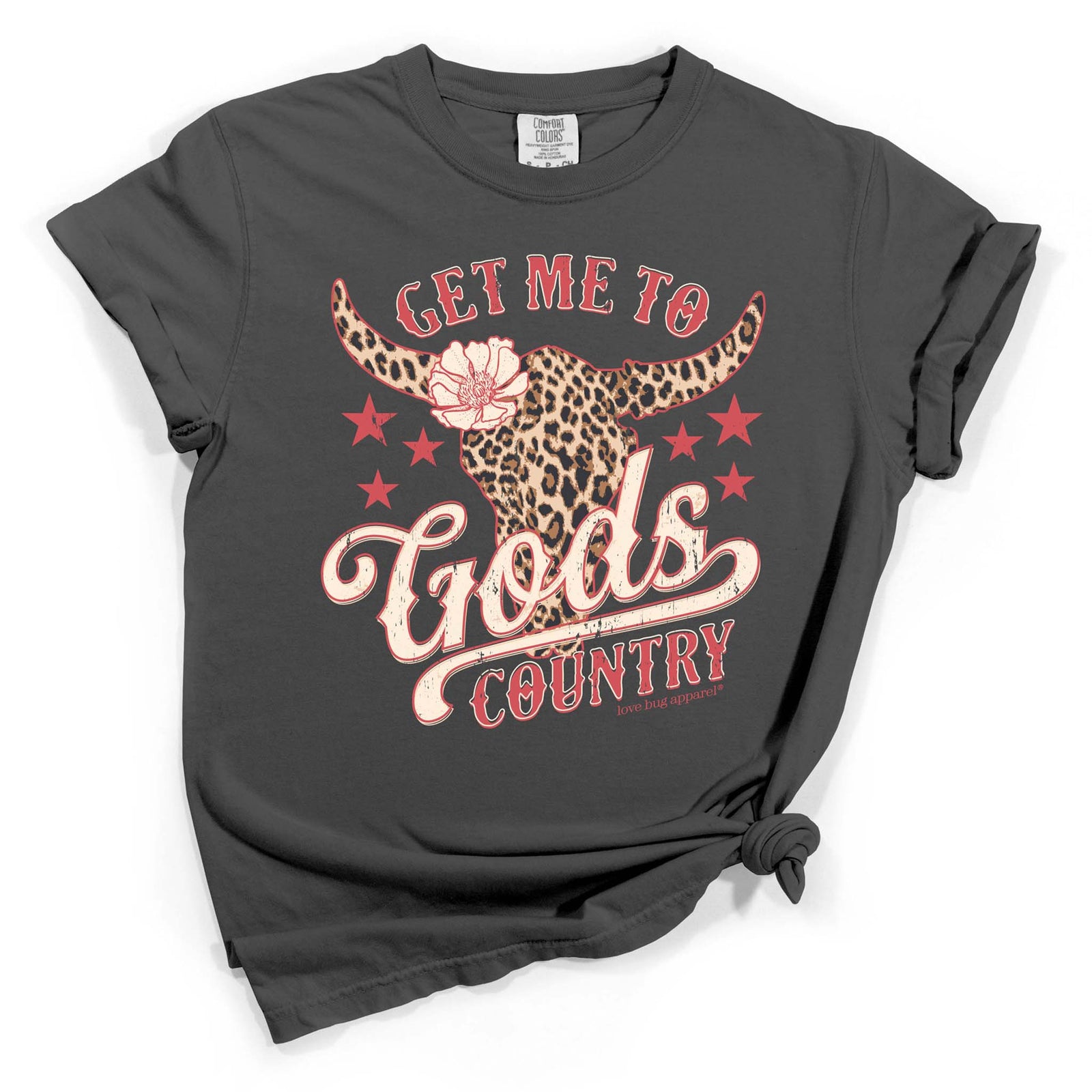 Dark gray short sleeve t-shirt with red and cream text reading “Get Me to God’s Country” and a leopard print longhorn graphic with stars.