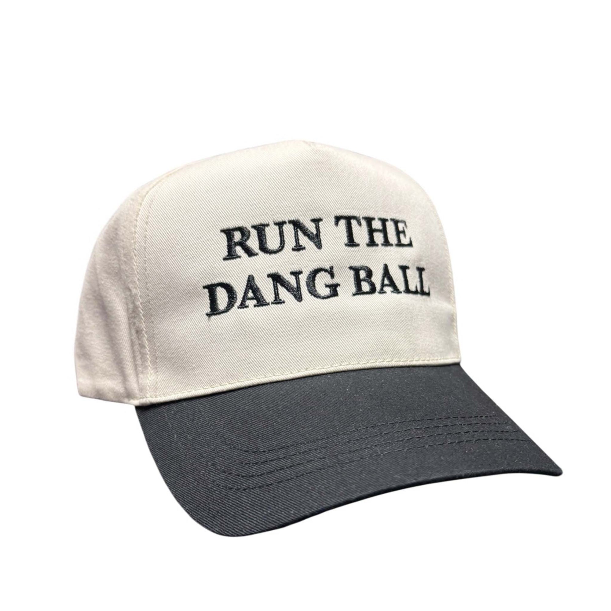 Neutral and black two-tone baseball hat with “Run the Dang Ball” text embroidered on the crown.