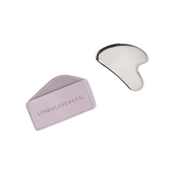 White gua sha tool with pink leather case on a white background, featuring the Lemon Lavender brand.