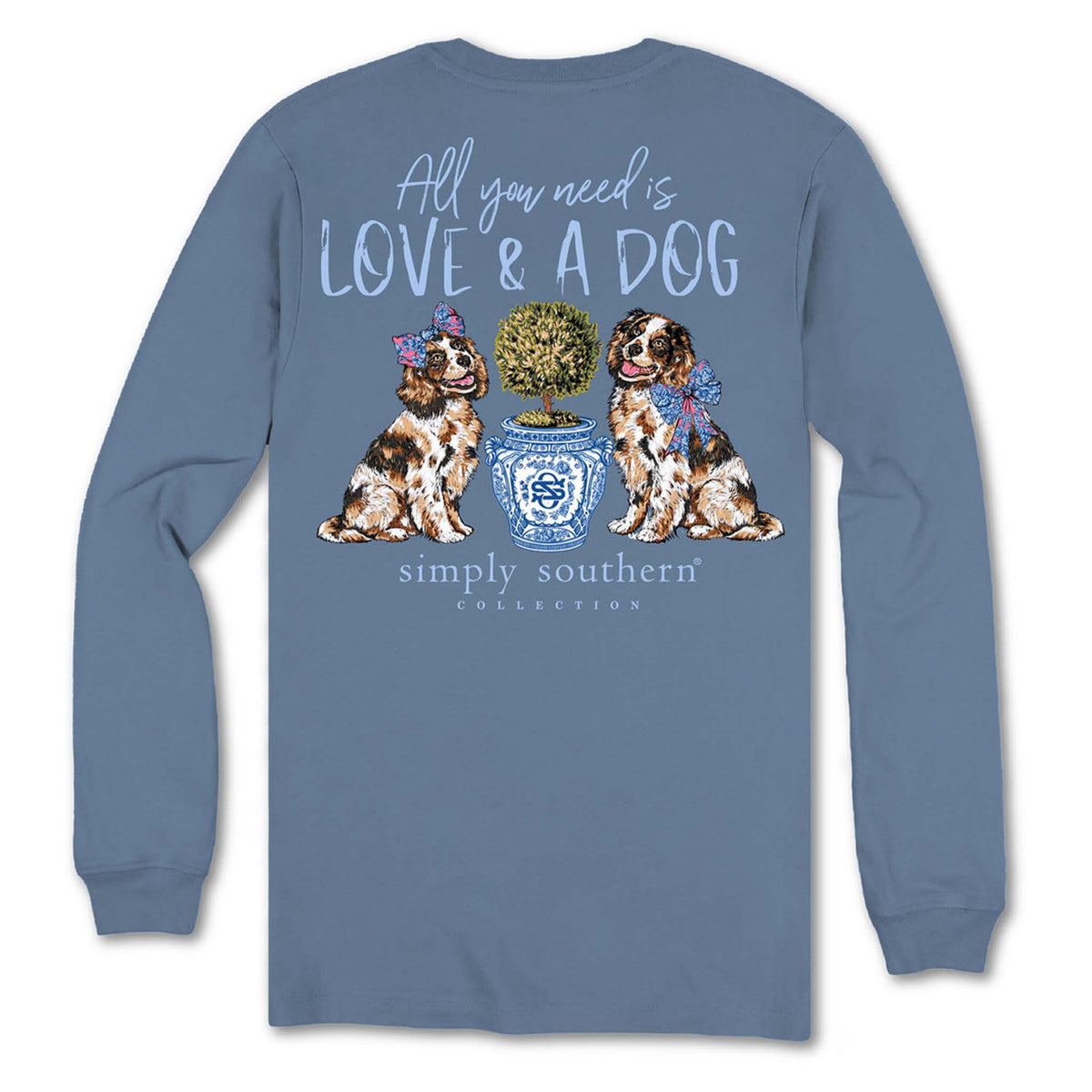 Back view of Simply Southern long sleeve shirt in slate blue with two dogs sitting beside a blue patterned planter and text that reads “All You Need Is Love & A Dog.”