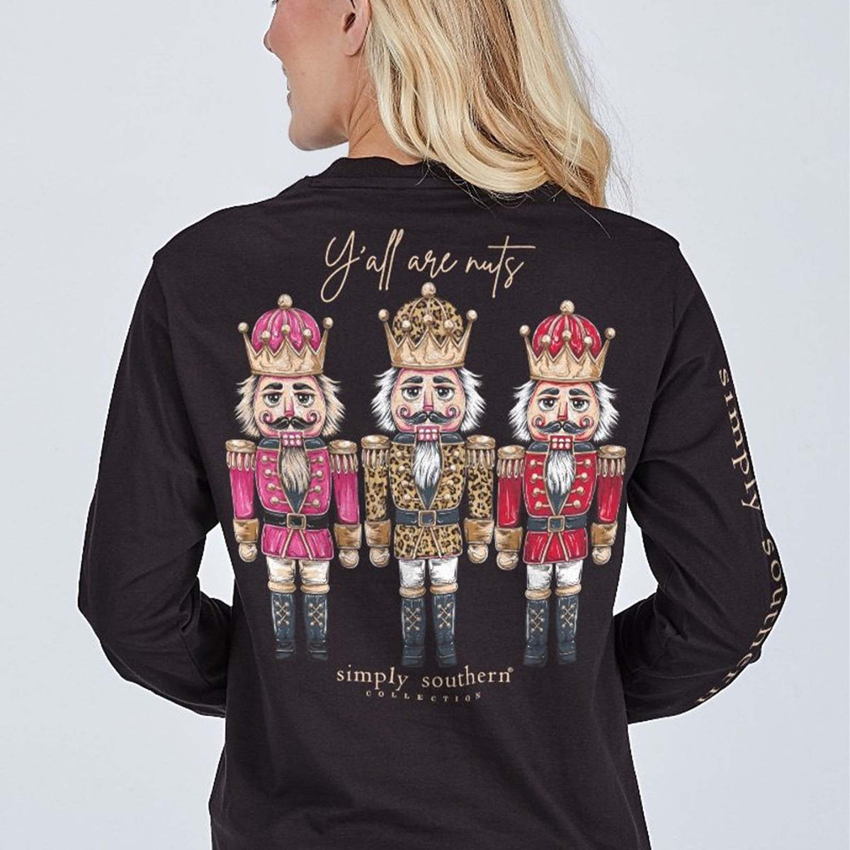 Black long sleeve shirt with the phrase 'Y'all are nuts' and a trio of nutcrackers. Simply Southern logo below, on left chest, and along right sleeve.