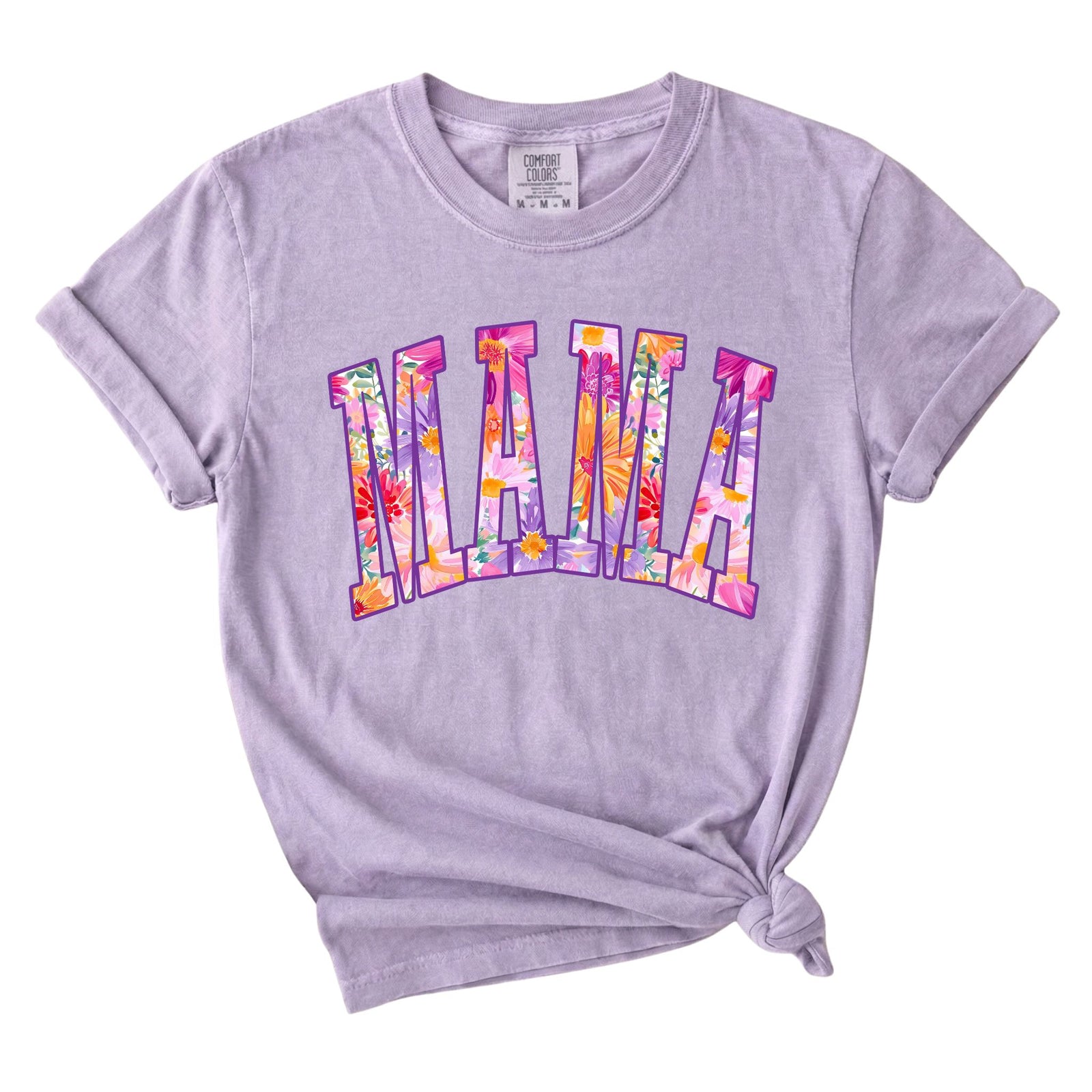 Light purple t-shirt with “MAMA” floral graphic on front, styled with rolled sleeves and knotted hem.