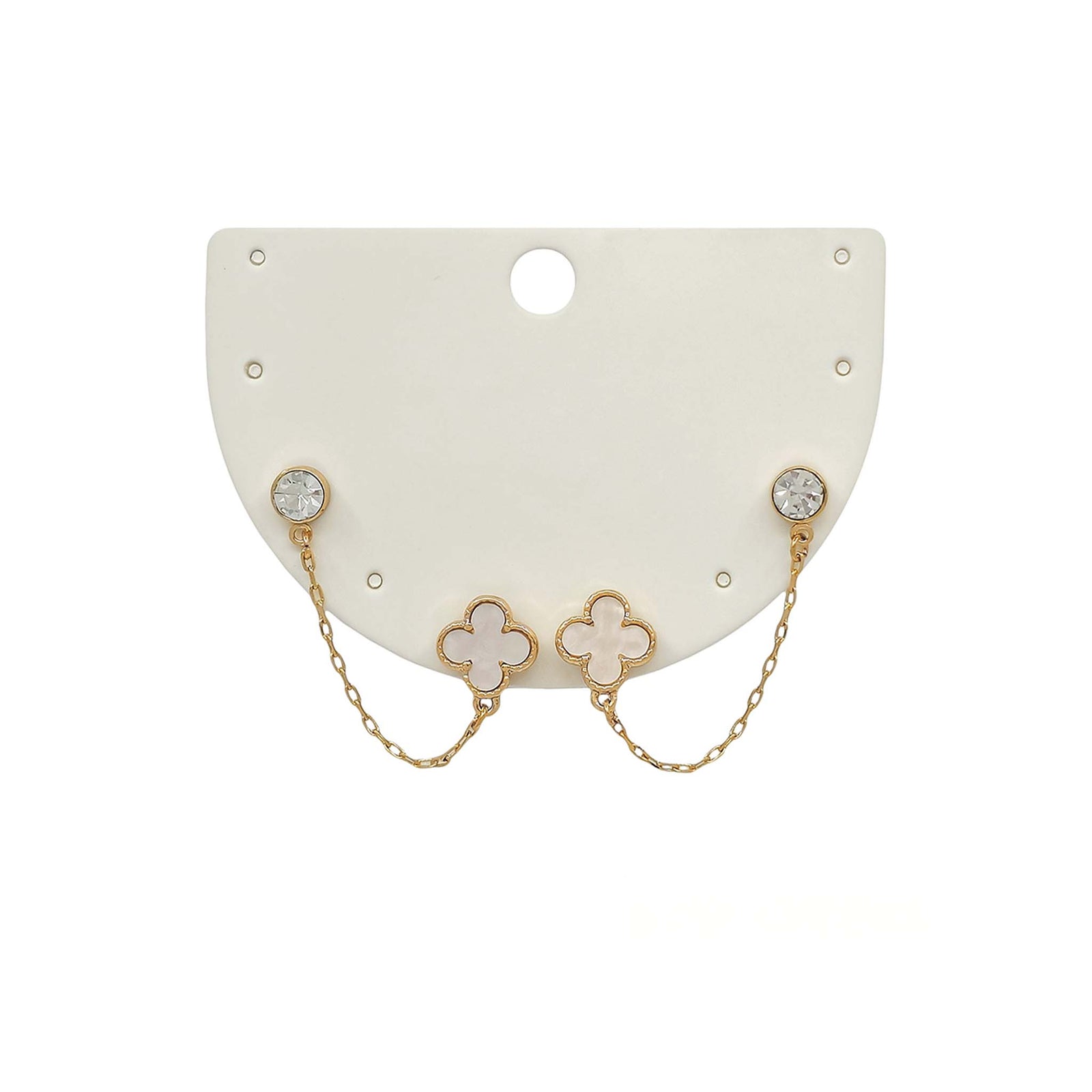 Pair of earrings with clover-shaped designs on a white card