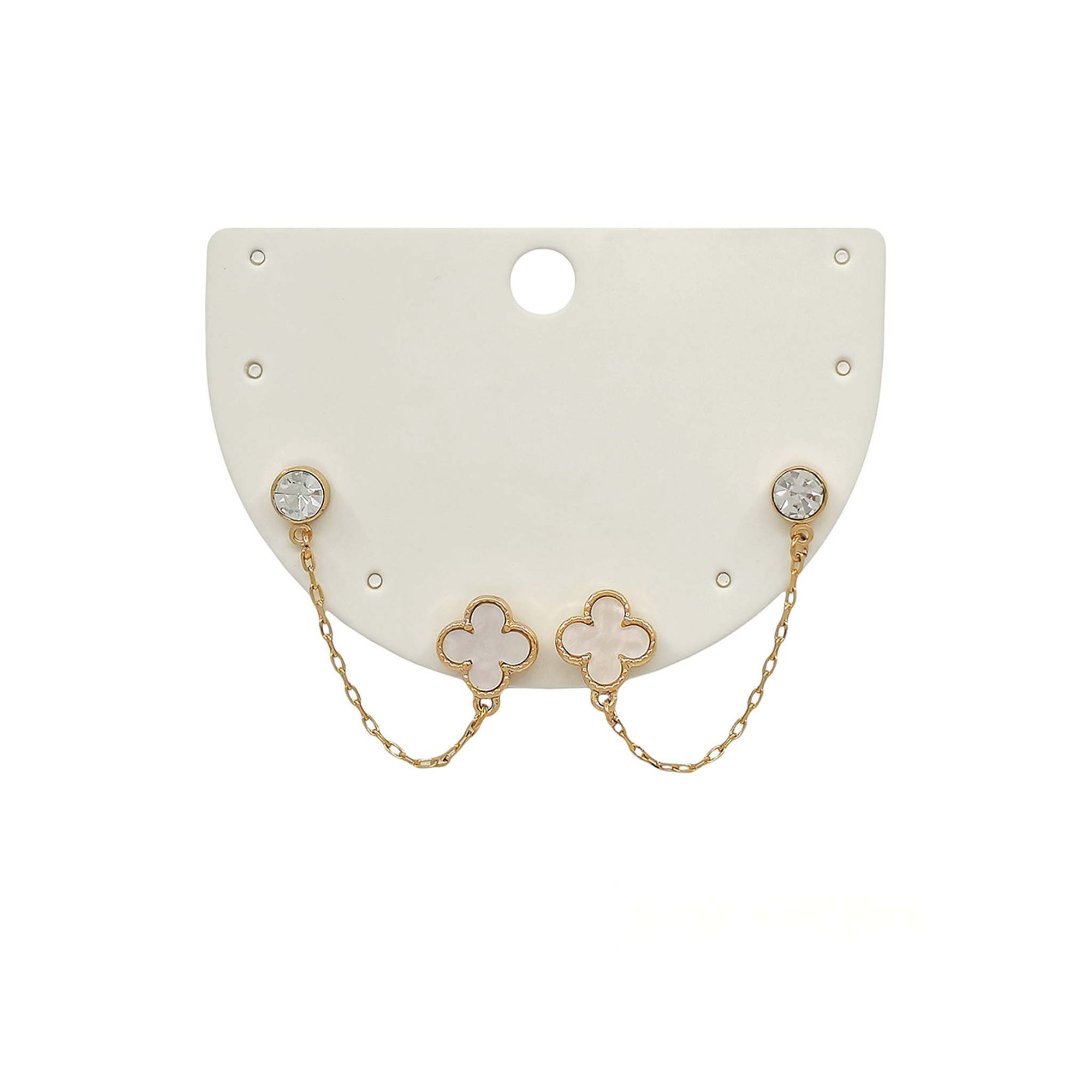 Pair of earrings with clover-shaped designs on a white card