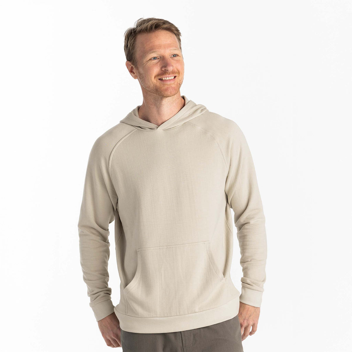Man wearing a beige activewear hoodie on a white background