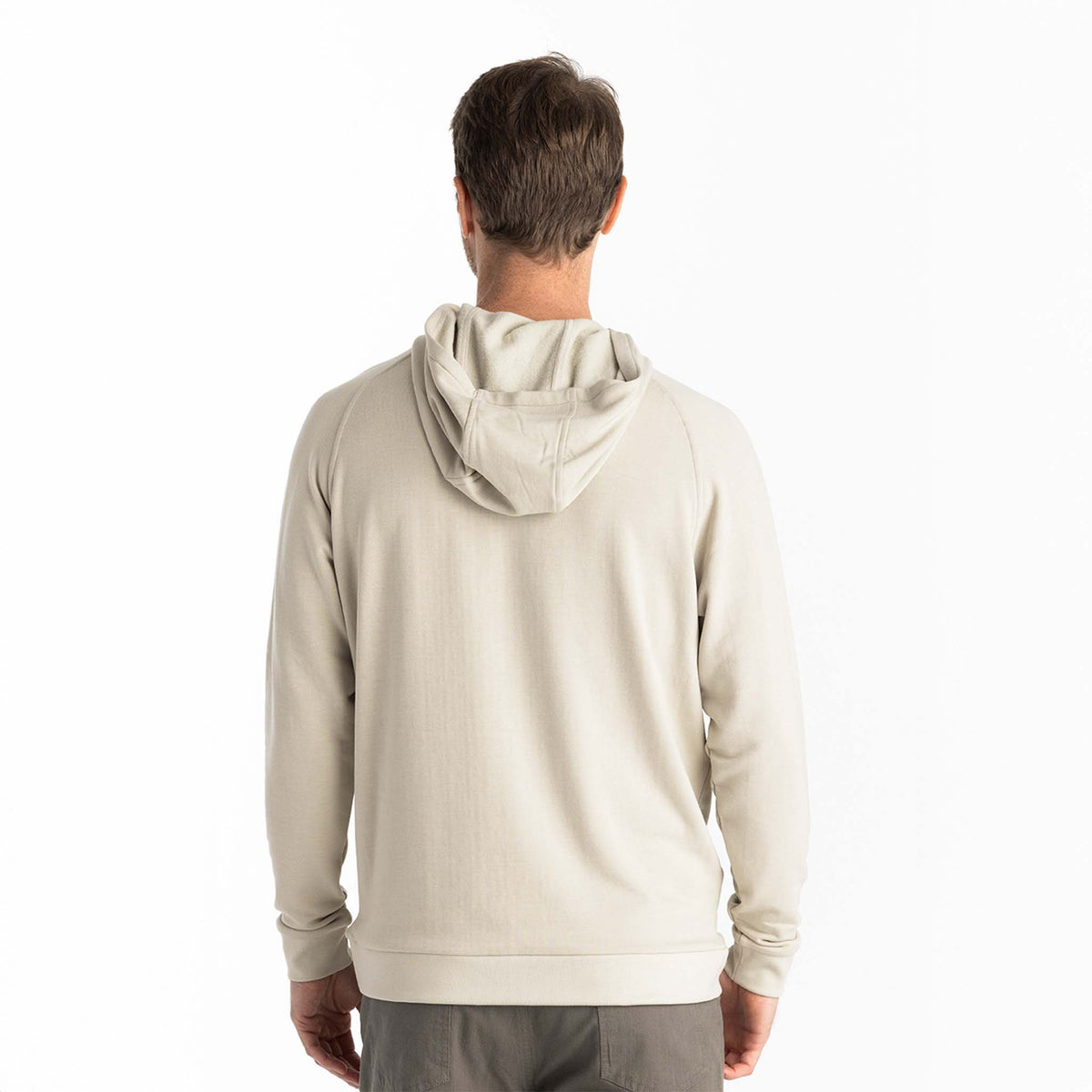 Man wearing a beige activewear hoodie from behind on a white background
