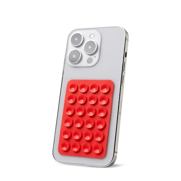 Red Tentacle Tech suction phone mount attached to the back of a silver smartphone, angled for display.