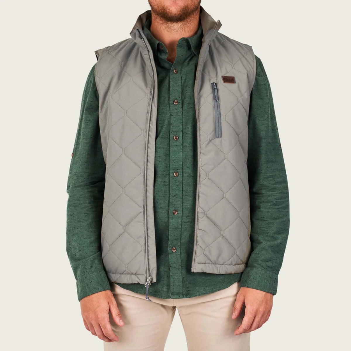 Man wearing Marsh Wear Men's Barnwell Vest in Rock Grey