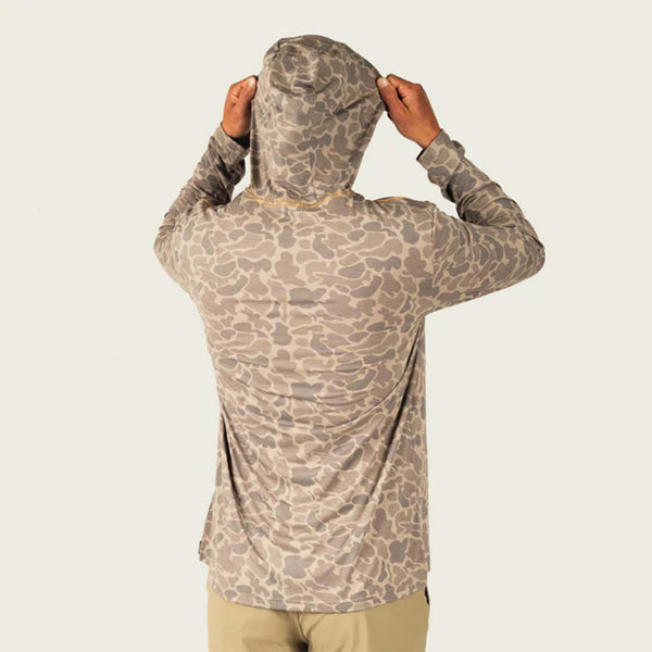 Marsh Wear Buxton Tech Hoodie in Camo, sizes S-XXL. Back view of hoodie worn, model lifting hood, showcasing khaki mallard camo pattern.