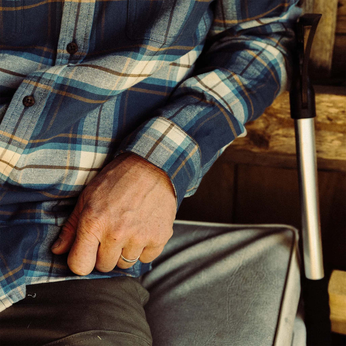Close up of man in a blue plaid shirt.