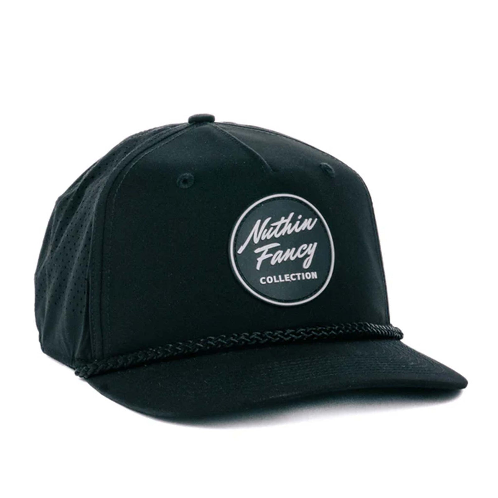 Black performance trucker hat made from moisture-wicking fabric, featuring laser perforated side and back panels for breathability. Includes a white-accented rubber 'Nuthin’ Fancy' patch on the front, a stylish black rope detail above the pre-curved bill, and an adjustable plastic snapback closure. One size fits most (58 cm).