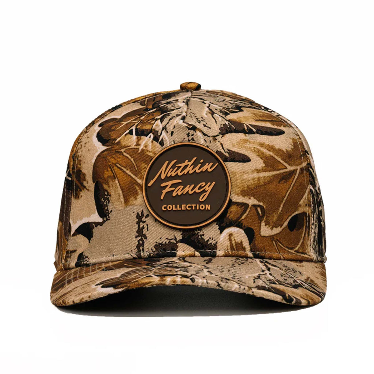 Front view of brown camo cap with curved bill and round “Nuthin Fancy Collection” patch on crown.