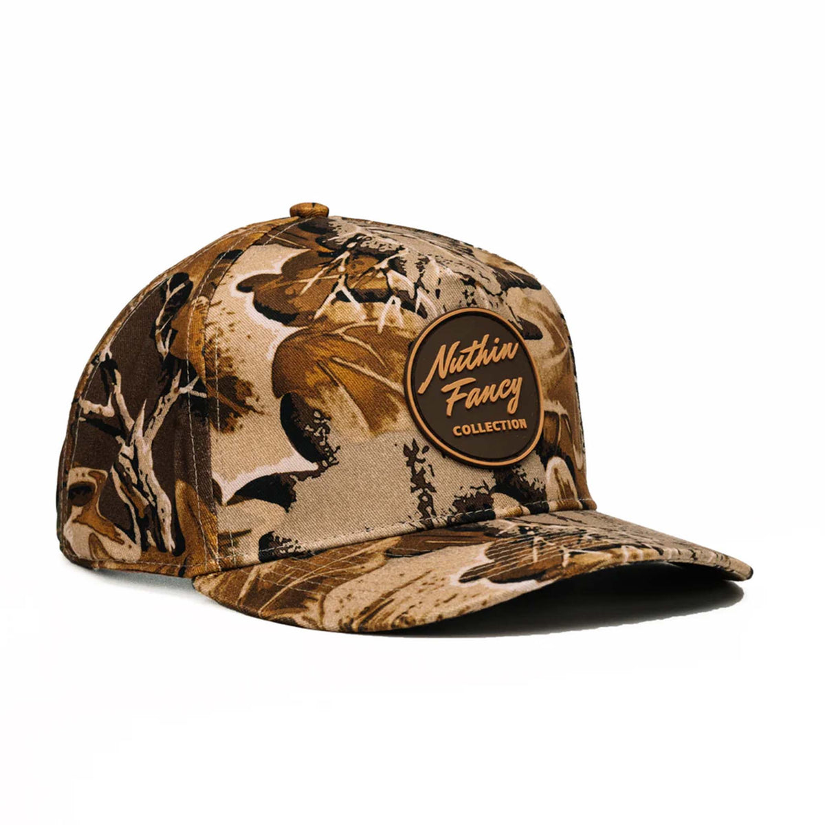 Angled view of brown camo cap with detailed leaf pattern and logo patch.