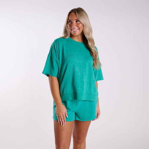 Woman wearing a green outfit on a white background