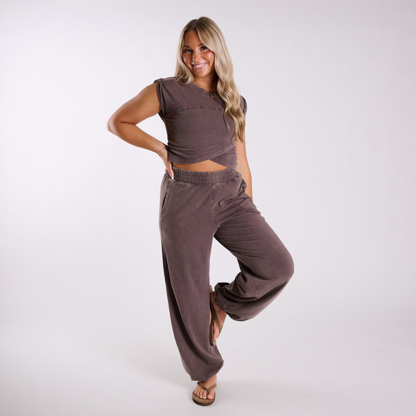 Chocolate brown lounge set shown from front angle, highlighting wide leg pants and cropped wrap-style top.
