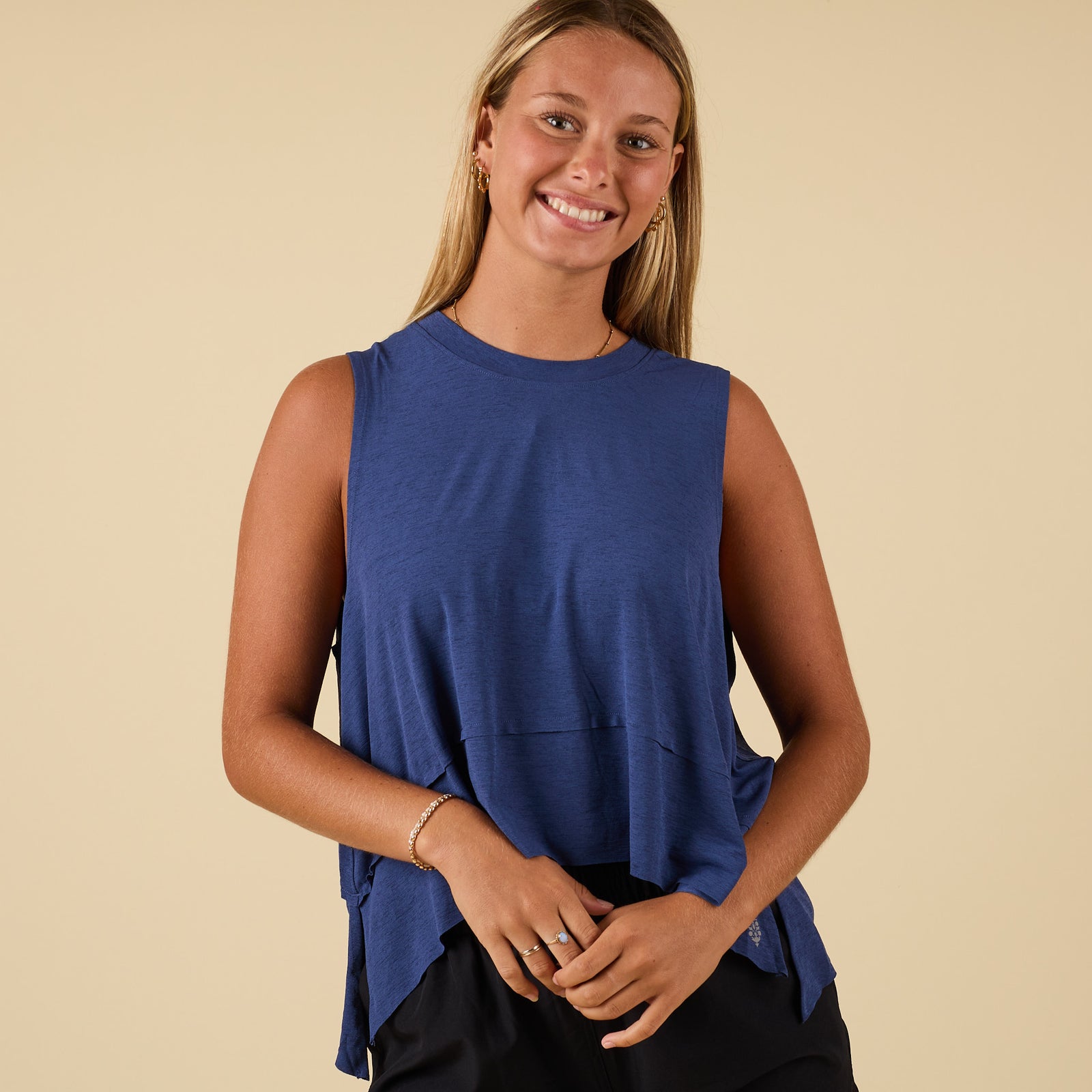 Front view of sleeveless Black Grape top with flowy layered hem.