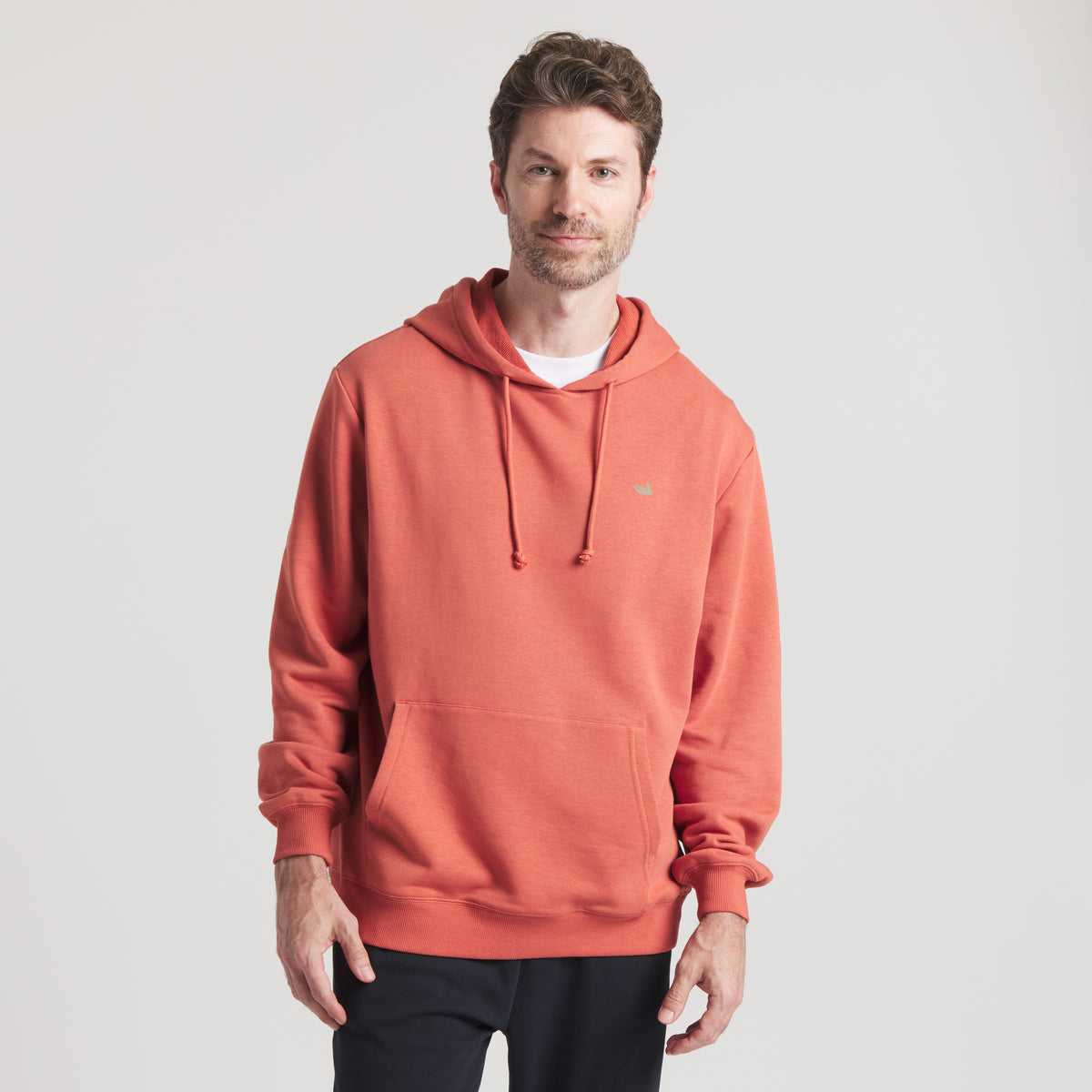 Man wearing a red hoodie on a light gray background