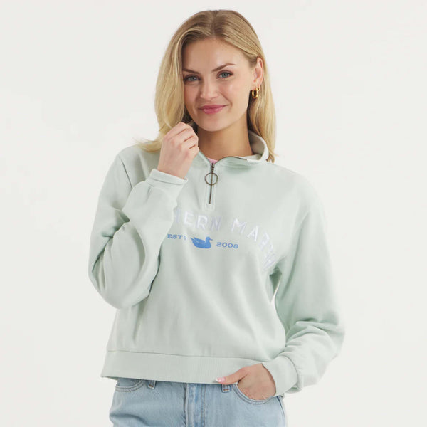 Woman wearing SEAWASH™ Vintage 1/4 zip crewneck in soft cotton with ribbed accents, front YKK ring-pull zipper, and embroidered Southern Marsh logo on chest.
