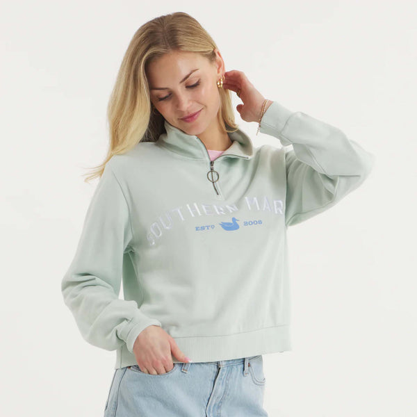 Woman wearing SEAWASH™ Vintage 1/4 zip crewneck in soft cotton with ribbed accents, front YKK ring-pull zipper, and embroidered Southern Marsh logo on chest.