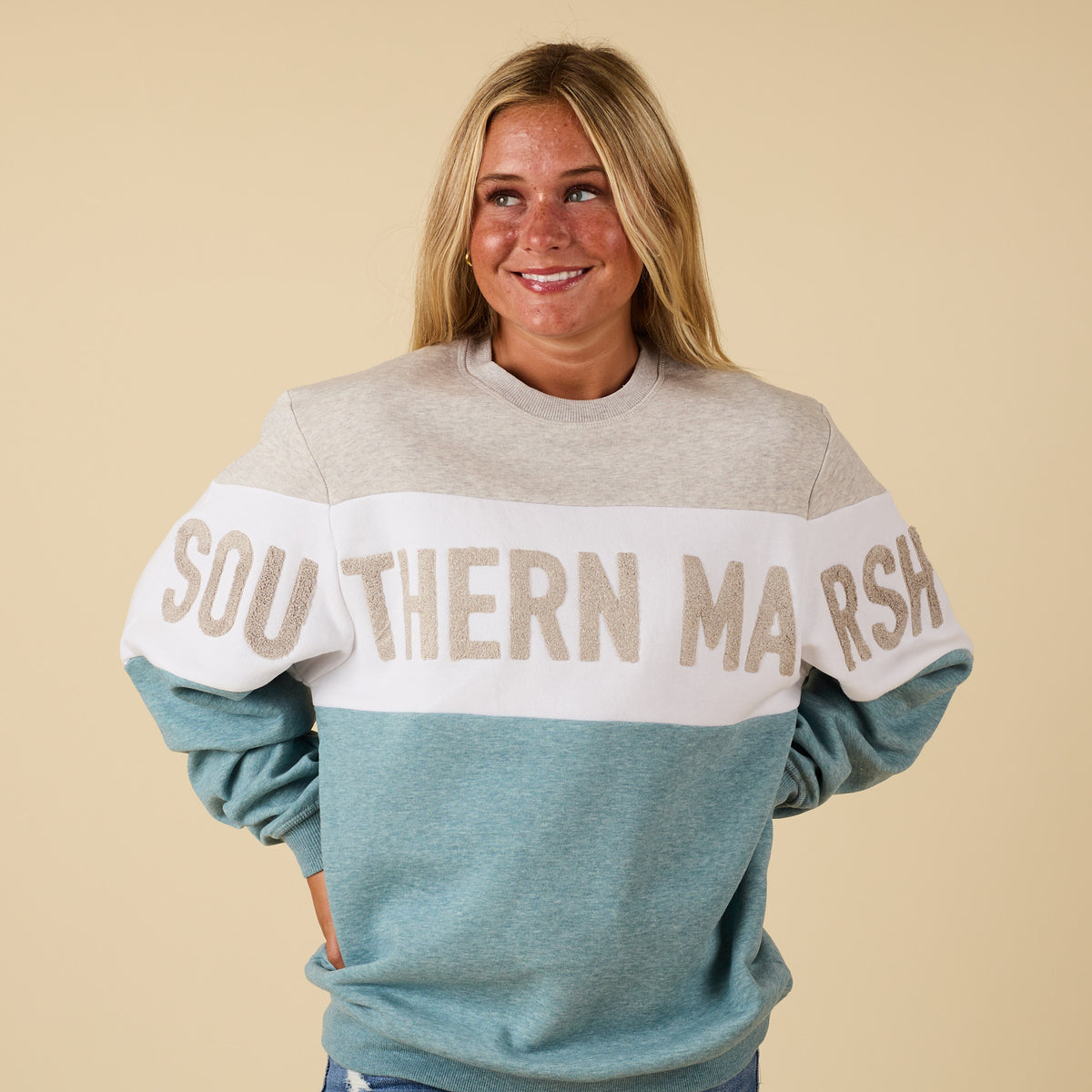 Front view of gray and teal Southern Marsh oversized sweatshirt with chenille applique lettering across chest and arms.