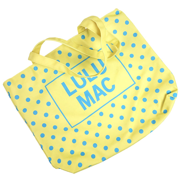  Bright yellow canvas tote bag with turquoise blue polka dot pattern and 'LULU MAC' branding on a white background