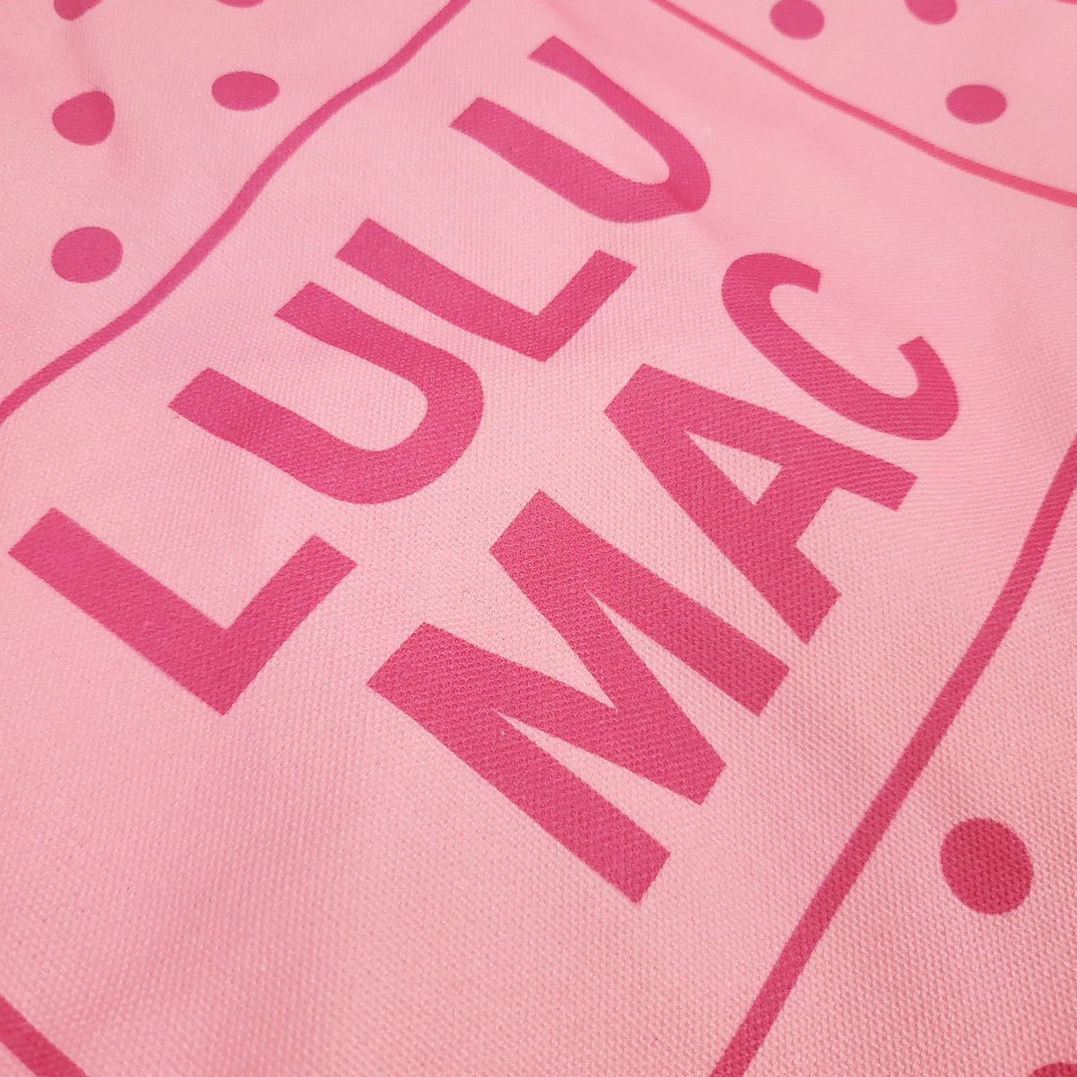 Light Pink/Hot Pink | Light Pink canvas tote bag with hot pink polka dot pattern and 'LULU MAC' branding on a white background