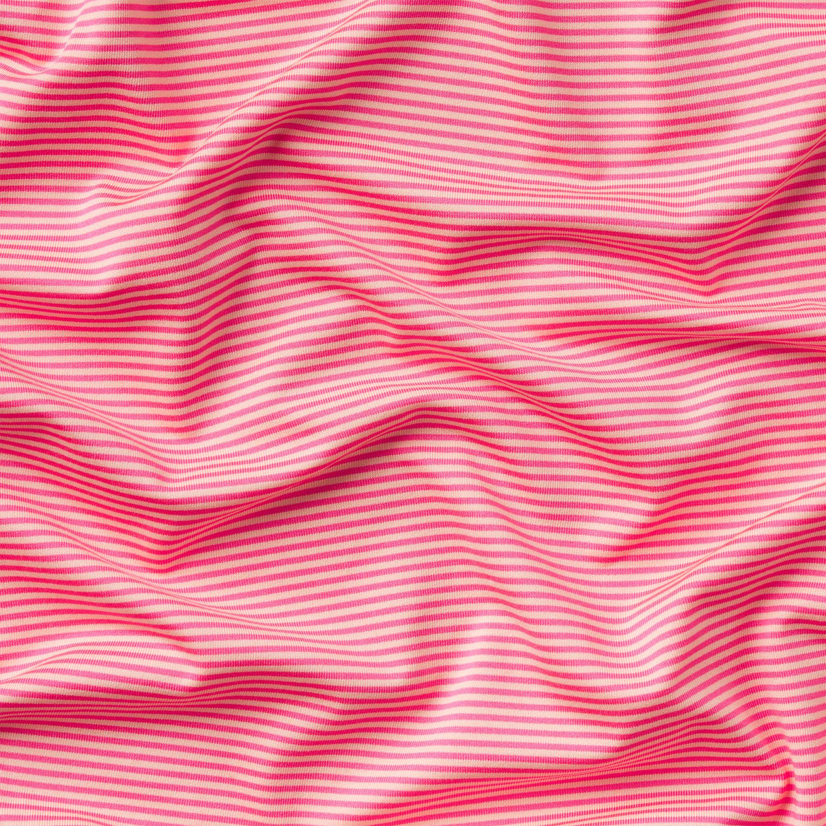 Close up of light peach and strawberry pink horizontal stripes.