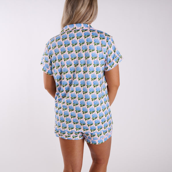 Pink pajama set back view with blue hydrangea print, short sleeve top, and matching shorts.