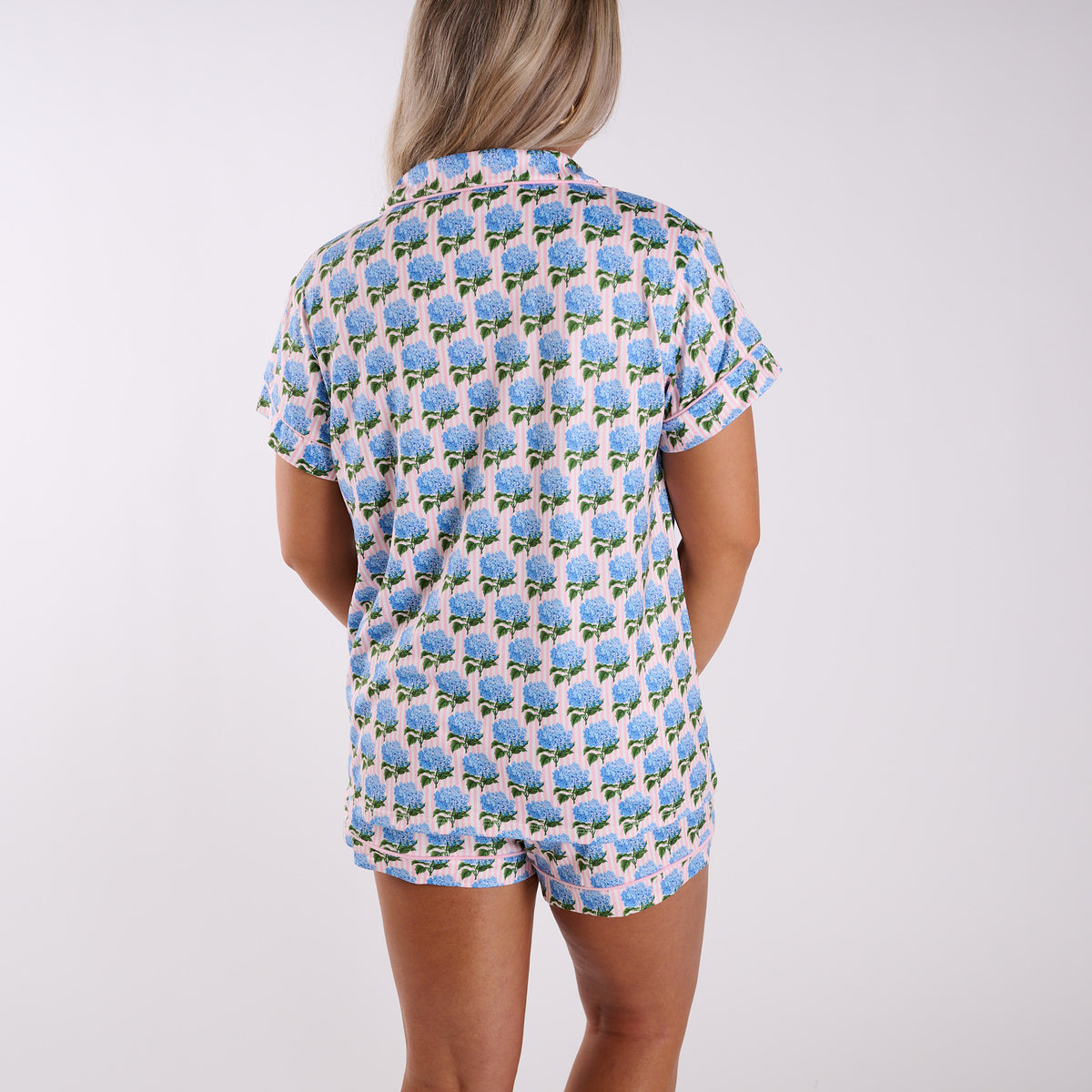 Pink pajama set back view with blue hydrangea print, short sleeve top, and matching shorts.